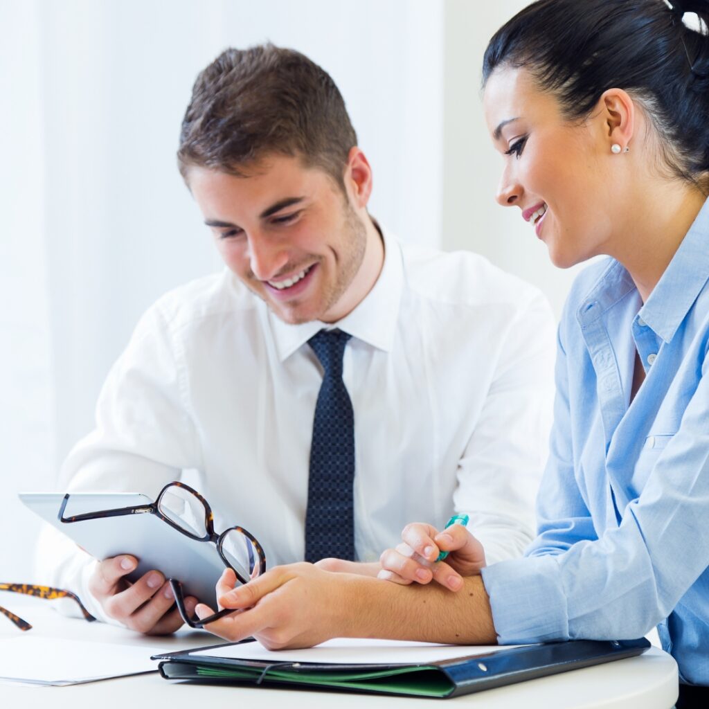 a man and woman looking at a tablet