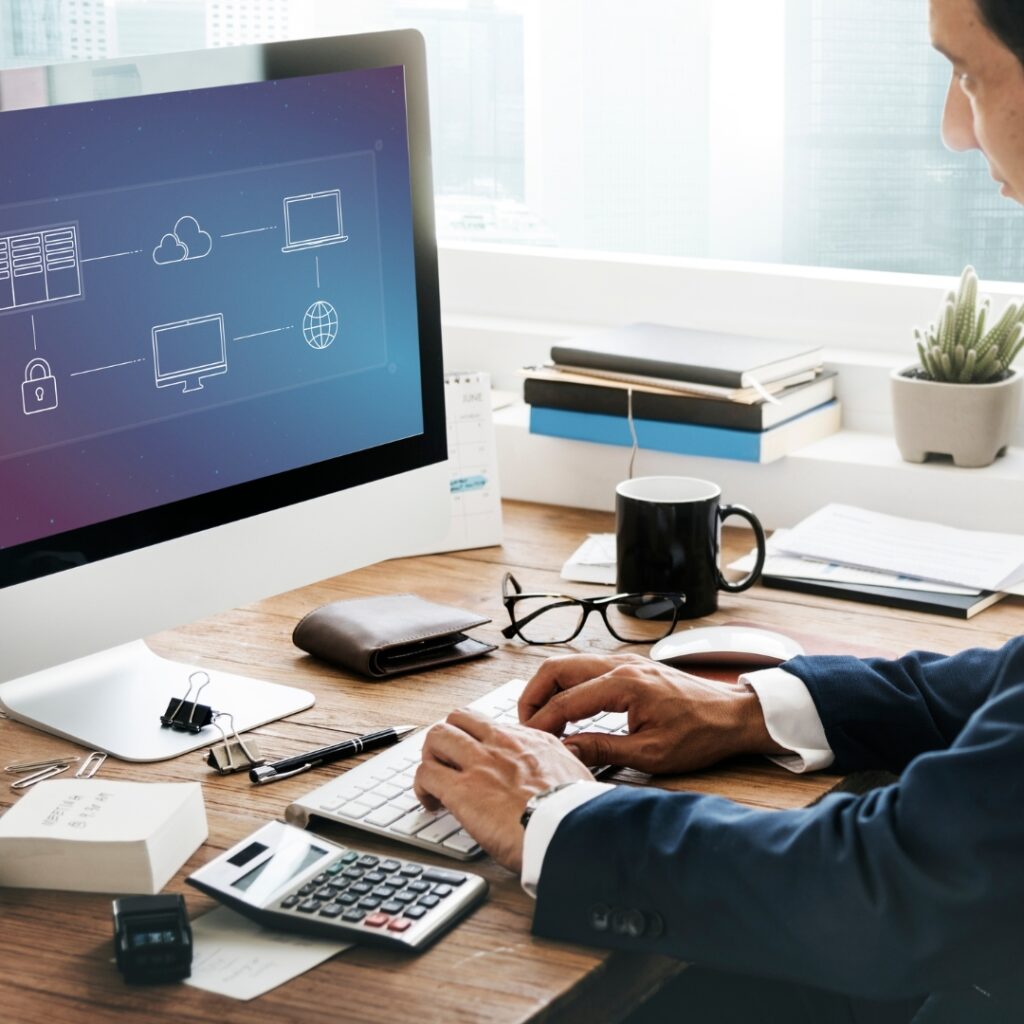 a man sitting at a desk using a computer