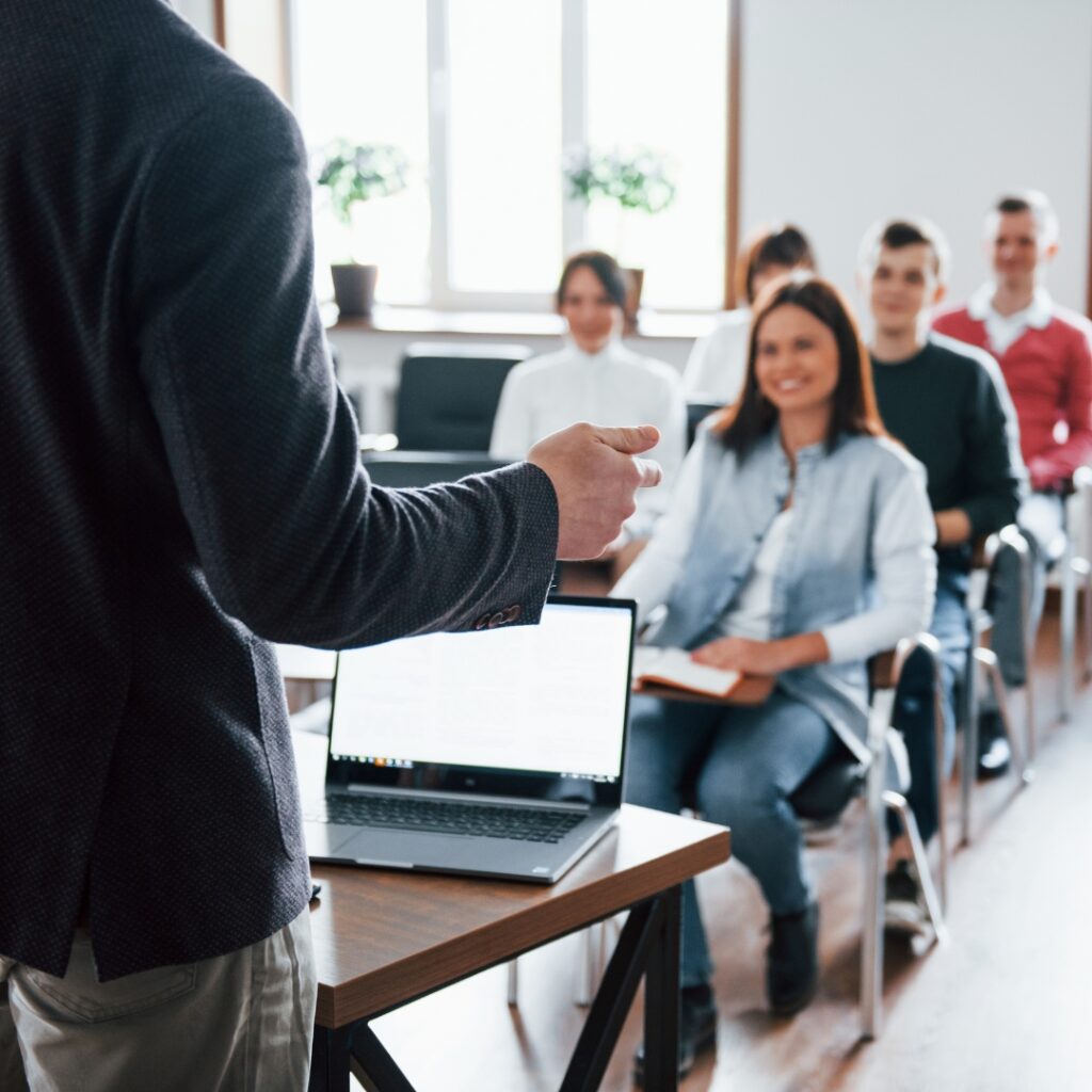 a man standing in front of a laptop